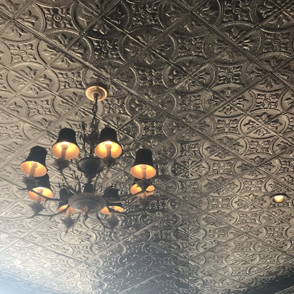 Henry Norman Hotel Outdoor Tin Ceiling and Chandelier Details.