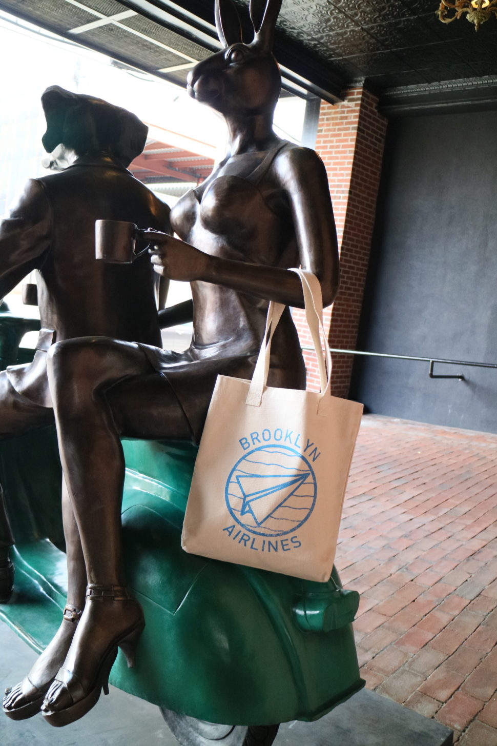 Henry Norman Hotel Outdoor Sculpture Details featuring Brooklyn Airliners Totes.
